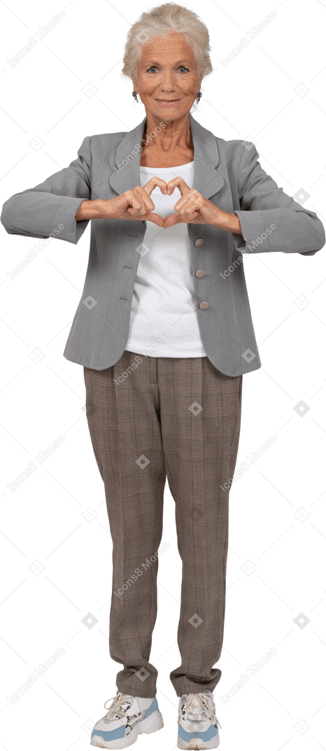 Front view of a happy old lady in suit making heart gesture with fingers