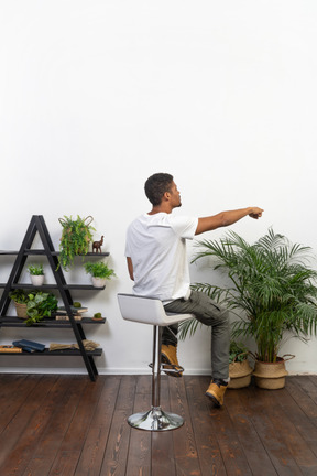 Good looking young man sitting on a chair