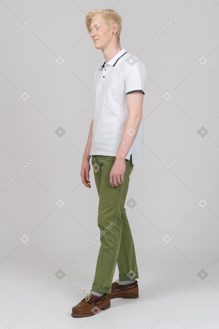 Young man standing still and smiling