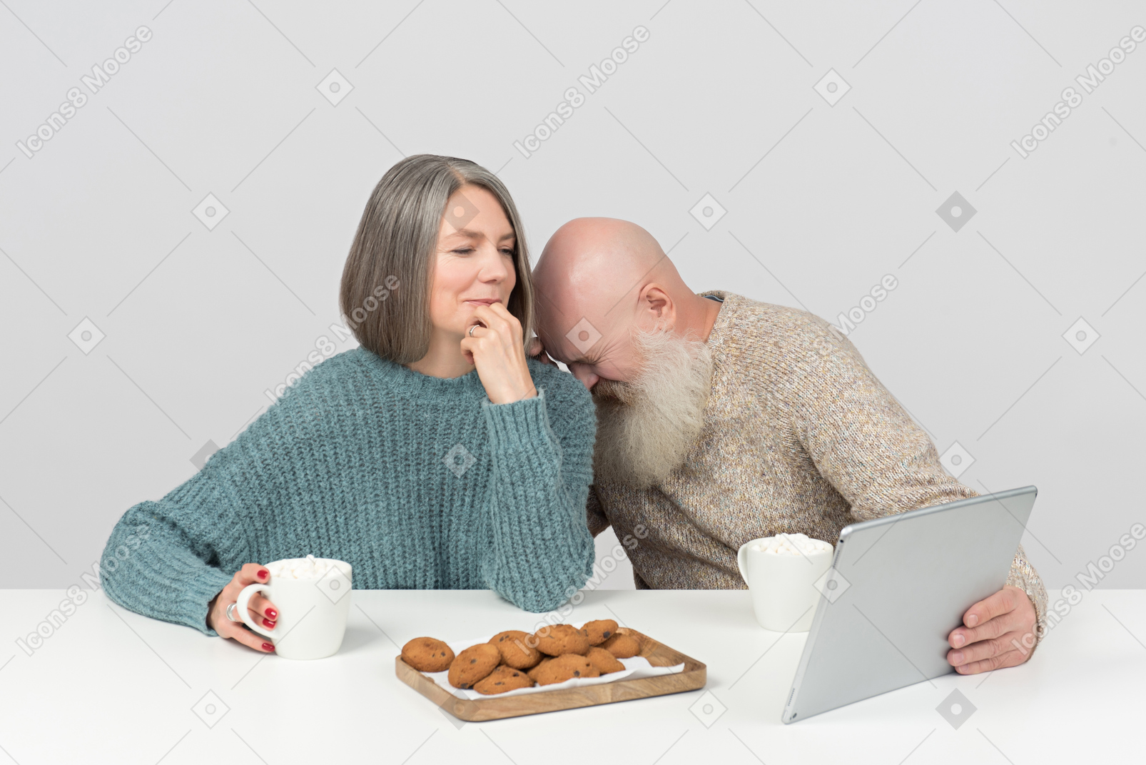 Aged man laughing hard while he and his wife watching movie on tablet