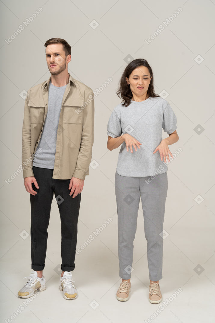 Front view of young couple being squeamish