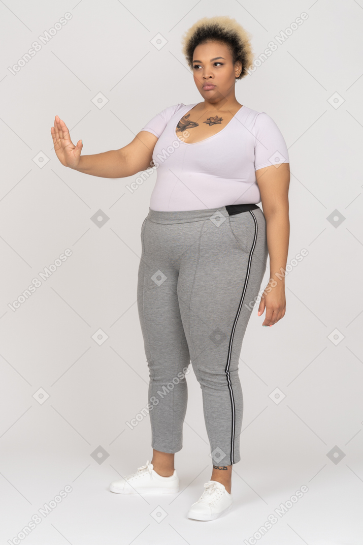Woman outstretching one arm making a stop gesture