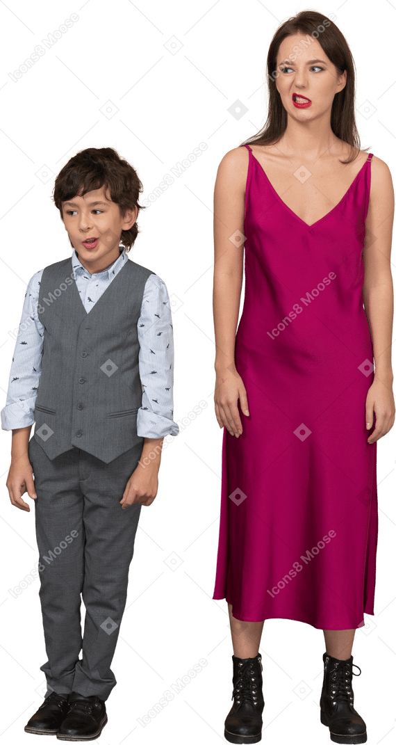 Front view of a grinning boy and woman in red dress