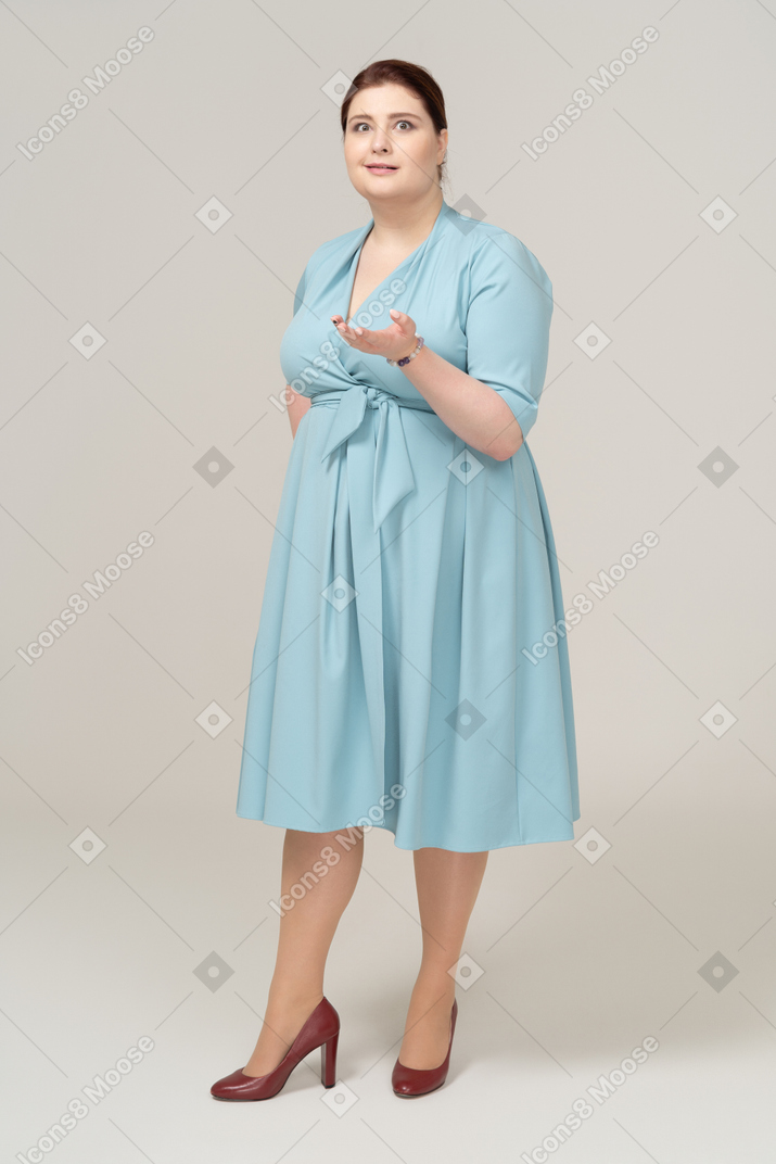 Front view of an impressed woman in blue dress