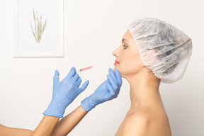 Vista laterale di una donna che riceve l'iniezione di botox