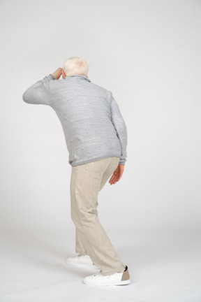 Back view of a man standing and looking away from camera