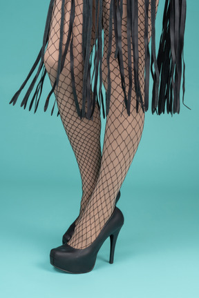 Close-up of legs in fishnets and high heels