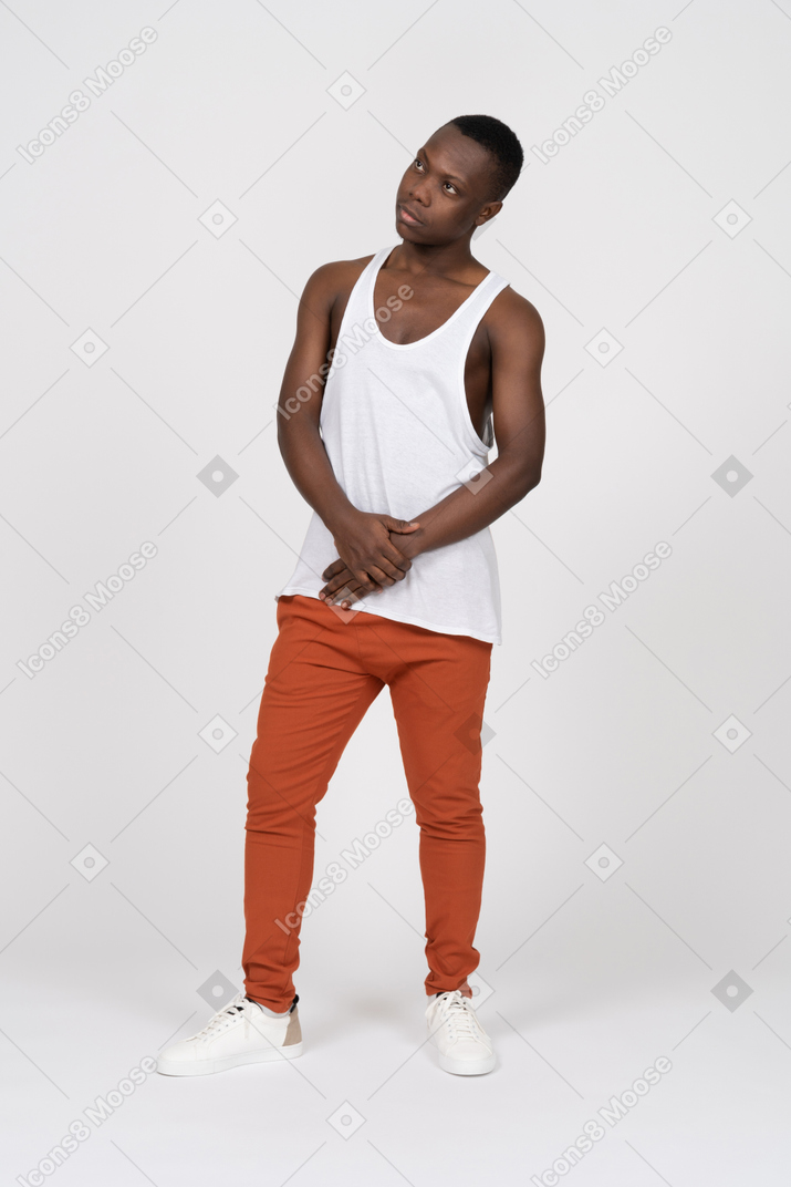 Man in tank top standing with hands together