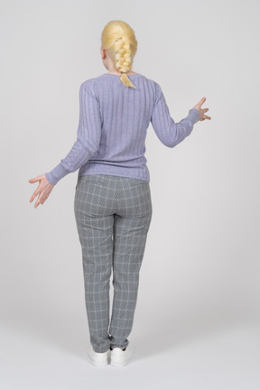 Rear view of young woman gesturing with hands