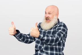 Mature bearded man showing thumbs up
