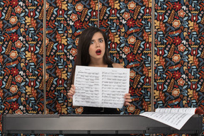 Overwhelmed female musician showing a musical notation