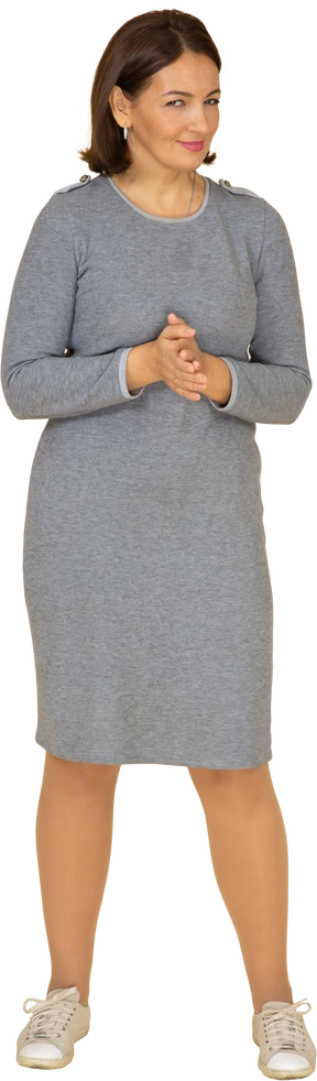 Front view of a happy woman in grey dress