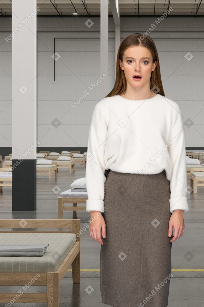 Shocked woman standing in a room with beds