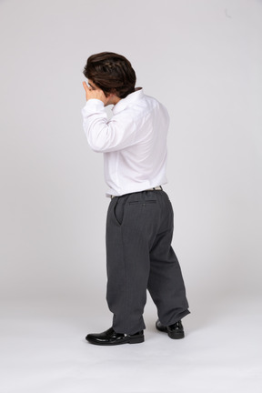 Back view of a man pretending to talk on the phone