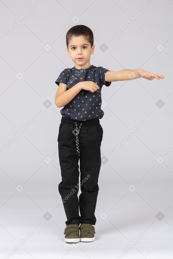 Front view of a cute boy showing direction