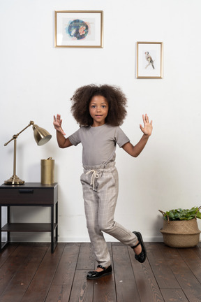 Good looking girl kid posing on the apartment background