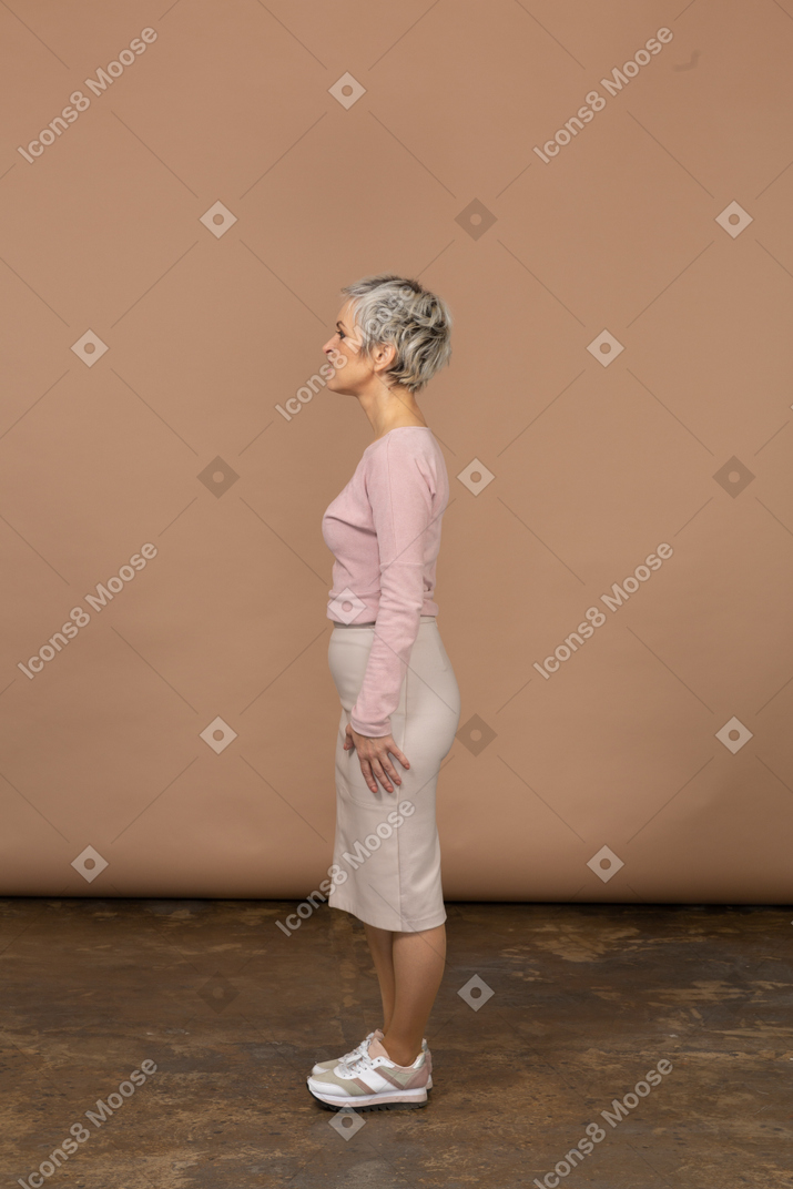 Side view of a woman in casual clothes making faces