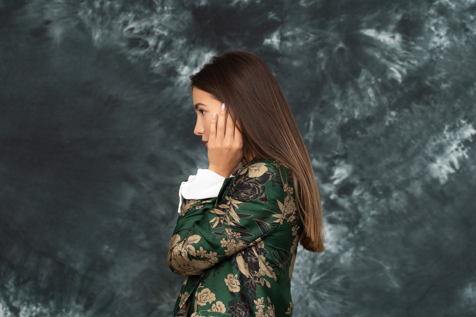 Side portrait of young businesswoman  touching her hair