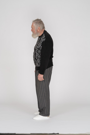 Side view of elderly man standing upright