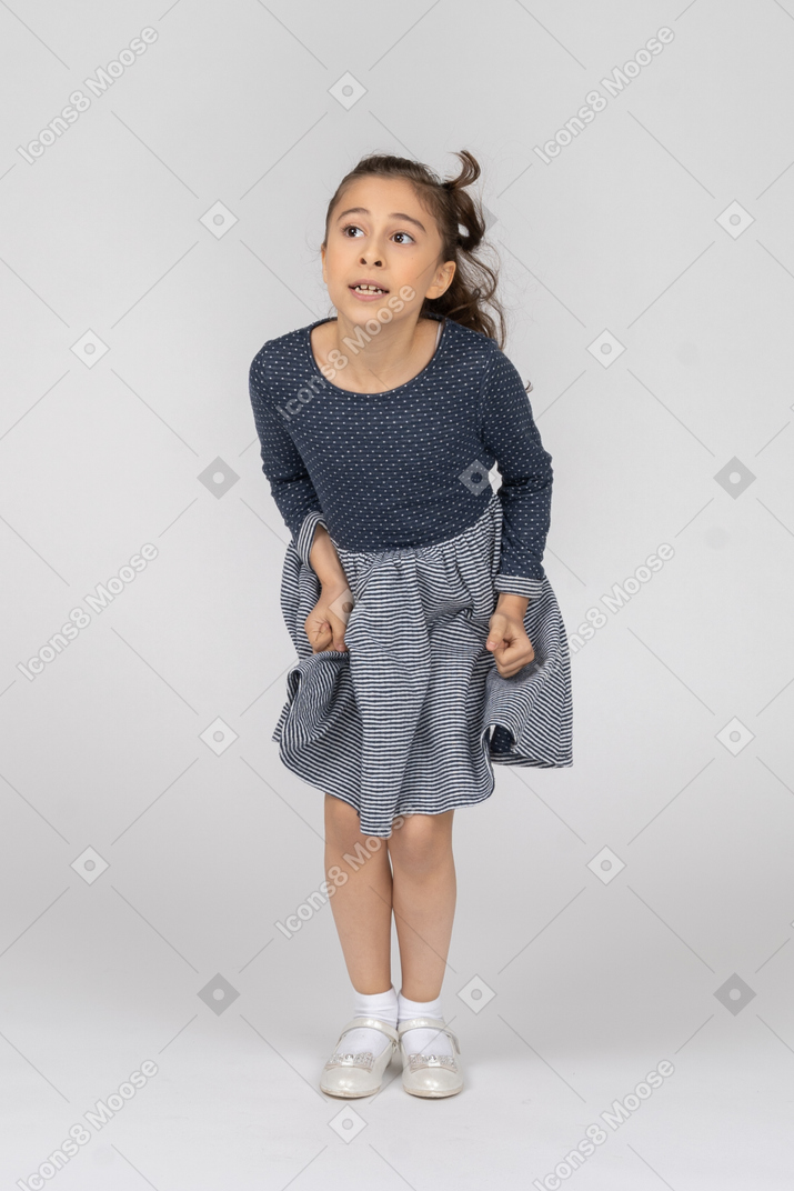 Front view of a girl bending forward in jumping motion