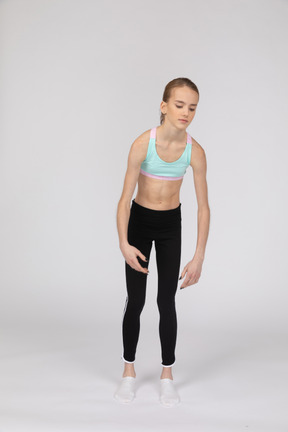 Side view of a weak teen girl in sportswear leaning forward