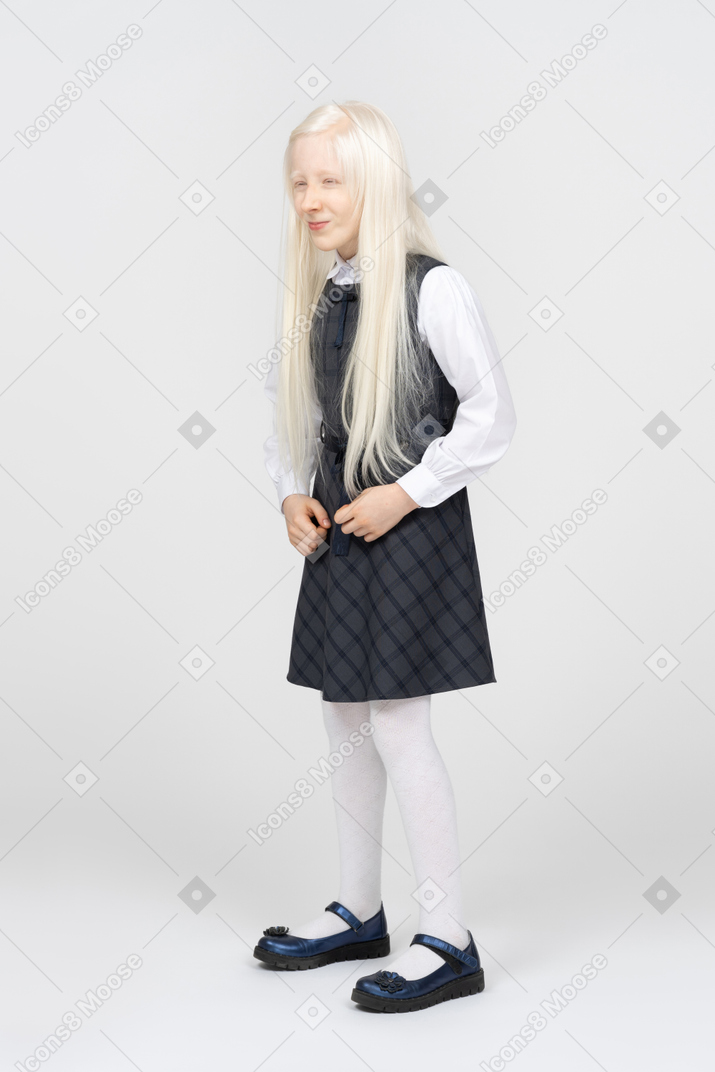 Schoolgirl making funny faces and squinting her eyes