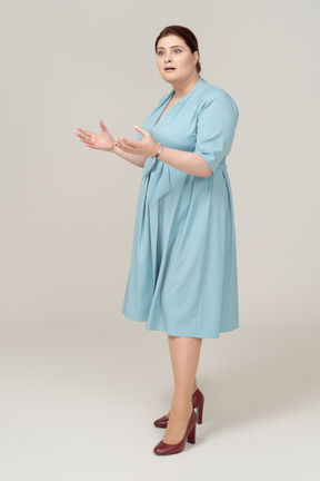 Front view of an impressed woman in blue dress