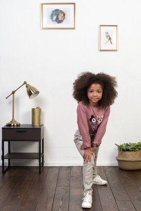 Cute girl kid posing on the apartments background