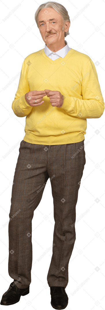 Front view an old smiling man wearing yellow pullover and putting hands together and looking at camera
