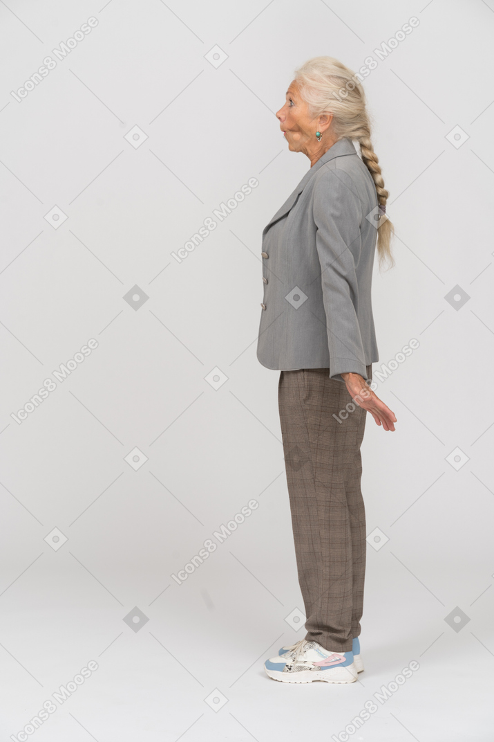 Old lady in suit posing in profile and making faces
