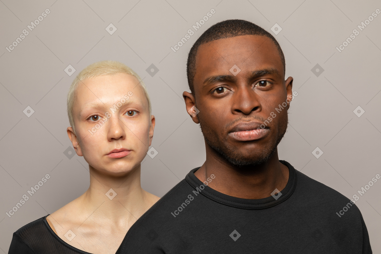 Young man and woman looking at camera