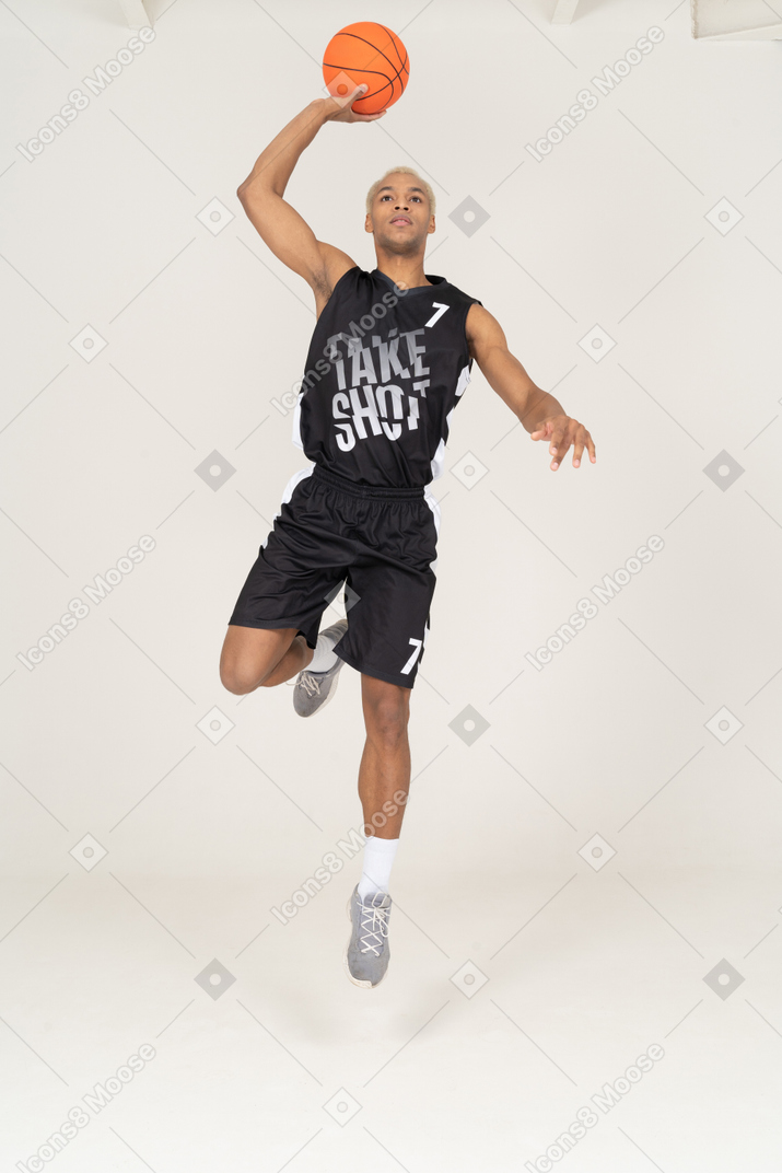 Front view of a young male basketball player scoring a point