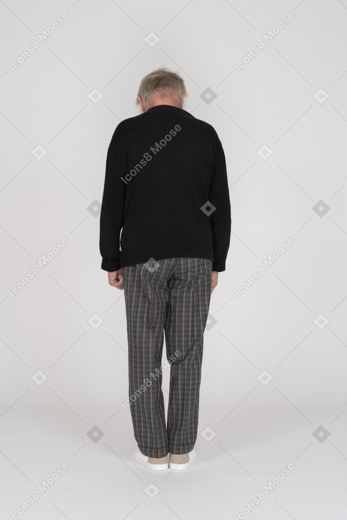 Elderly man standing back to camera