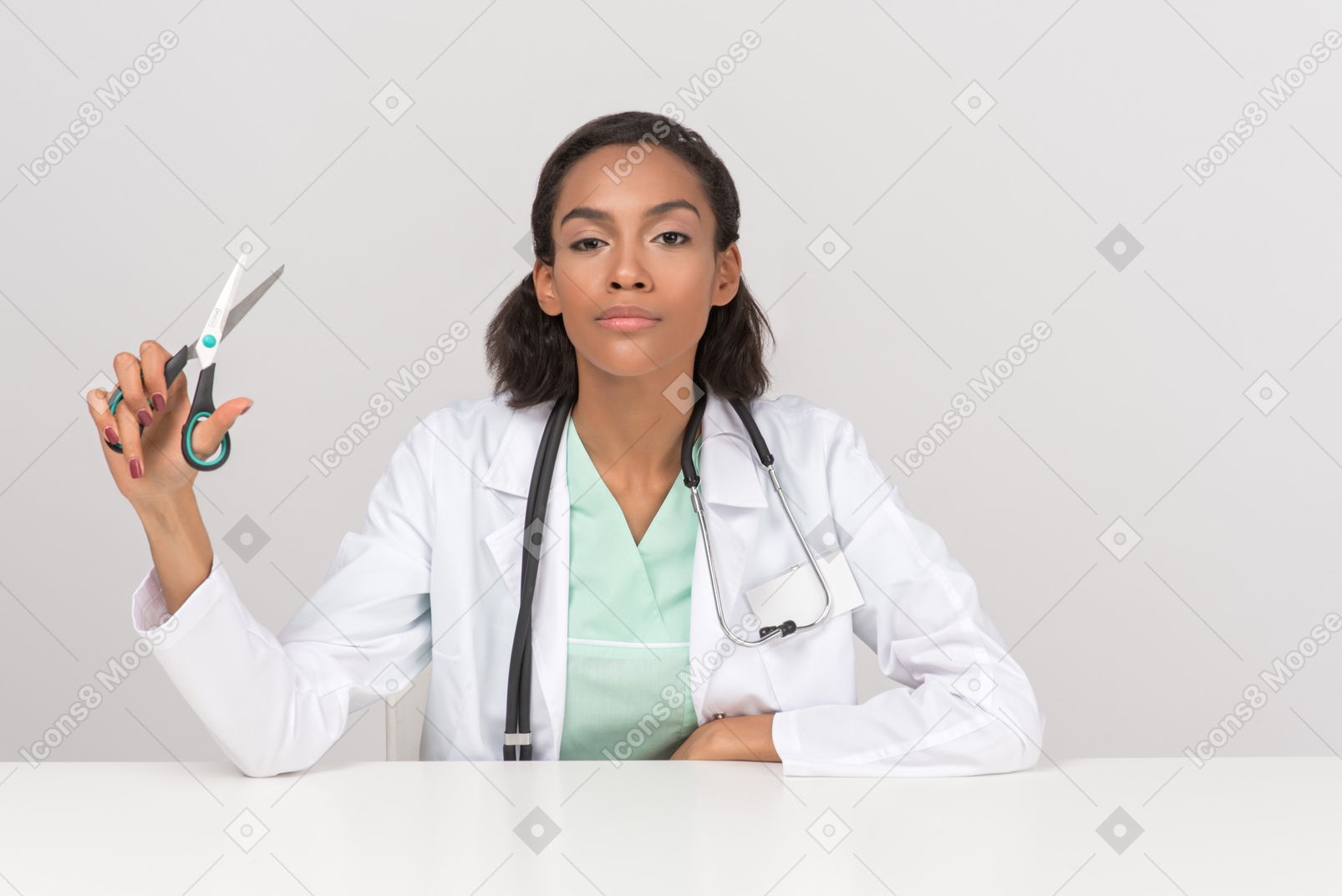 Beautiful female doctor holding scissors