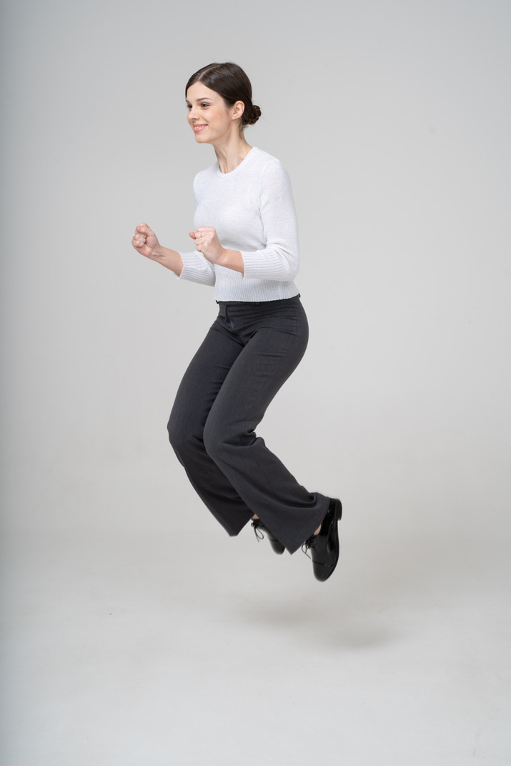 Woman in suit jumping