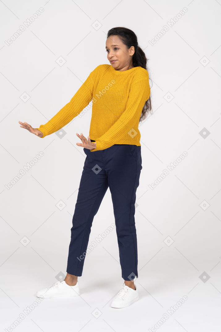 Front view of a scared girl in casual clothes showing stop gesture
