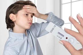 Female hand holding out glucose test for  a boy