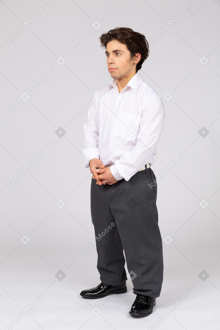 Male office worker standing with his hands folded