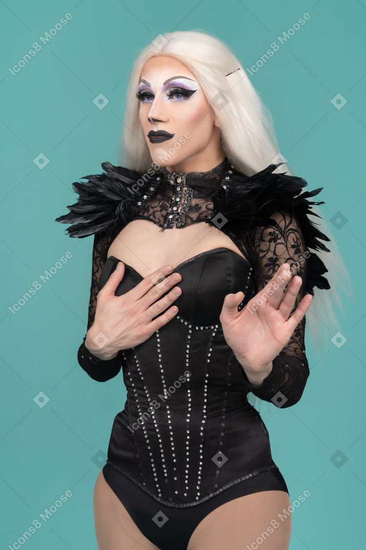 Drag queen with indifferent look raised palm in stop