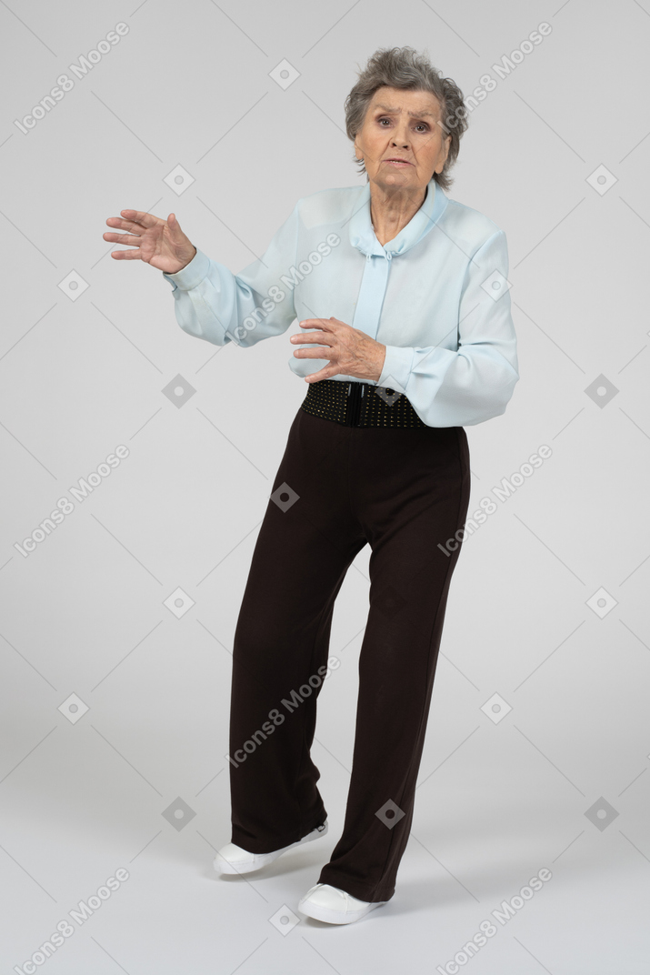 Front view of an old woman looking anxious in motion