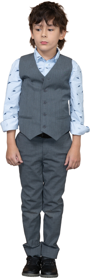 Front view of a cute boy in suit standing still