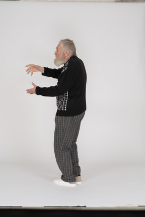 Side view of old man gesturing