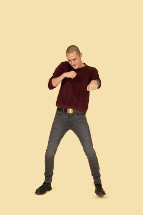 Front view of a young boxing man in red pullover