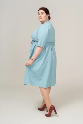 Side view of a happy woman in blue dress
