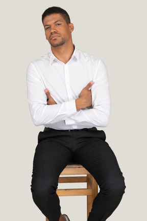 Good looking young man sitting on the chair