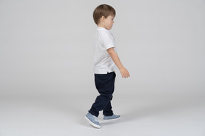 Side view of a boy walking with eyes closed