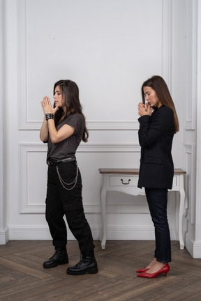 Two young women praying