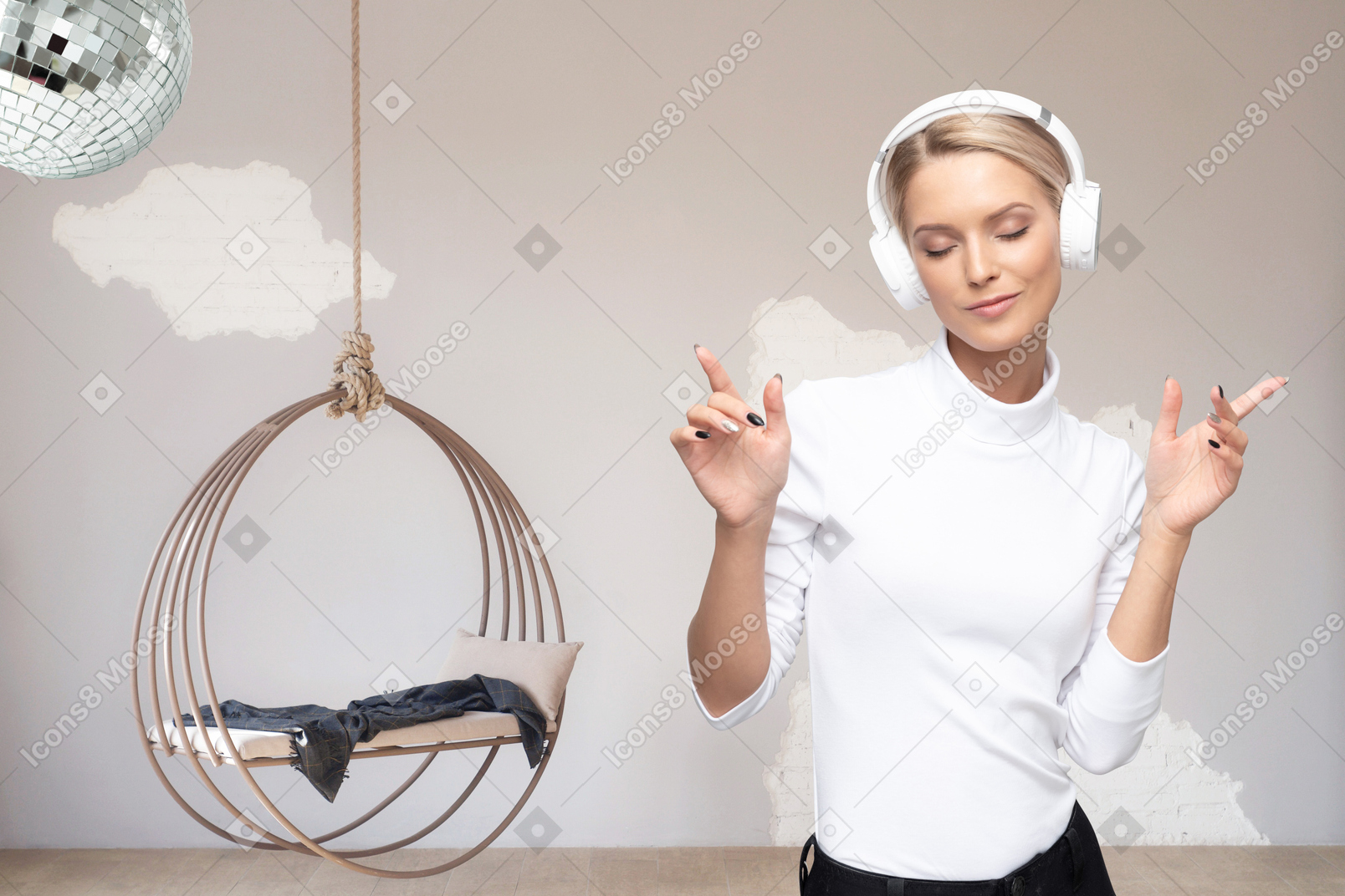 Woman with headphones standing in front of hanging chair