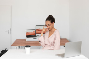 A woman sitting at a desk with a laptop