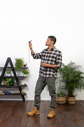 Side view of a tourist holding up a compass